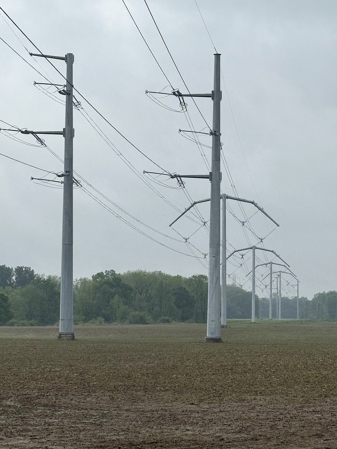 The power line lowering project to the east of the Warsaw Municipal Airport is “substantially complete.” The “umbrella-looking bowls” are what AEP calls their new BOLD (Breakthrough Overhead Line Design) line. They have two transition poles before and after to bring the lines down from the existing higher poles and then back up on the other side. Photo by Nick King, Warsaw Municipal Airport Manager