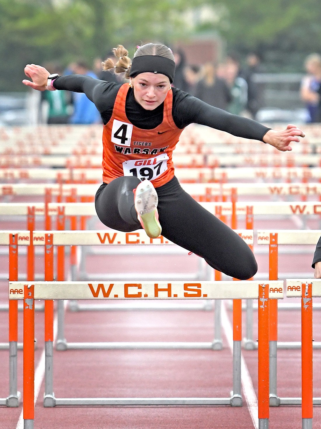 Senior Annabel Parker of Warsaw clears the last hurdle during the 100 Meter Hurdles race...Nieter